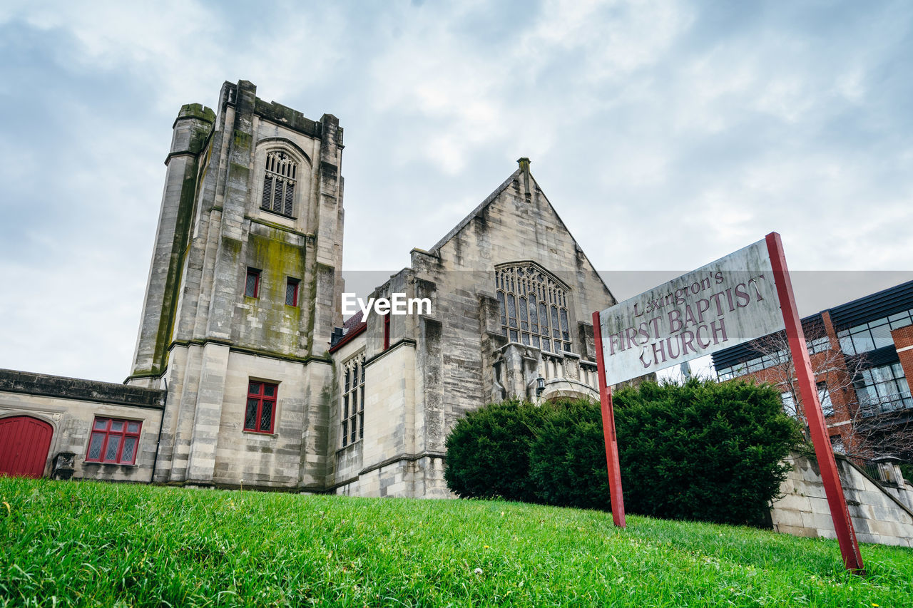 VIEW OF LAWN AND BUILDING AGAINST SKY