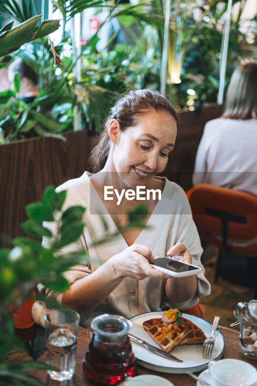 Woman having food at restaurant