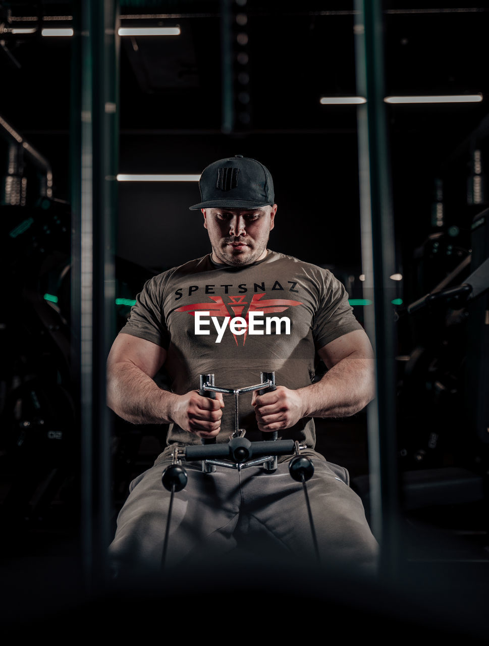 Rear view of man exercising in the gym 