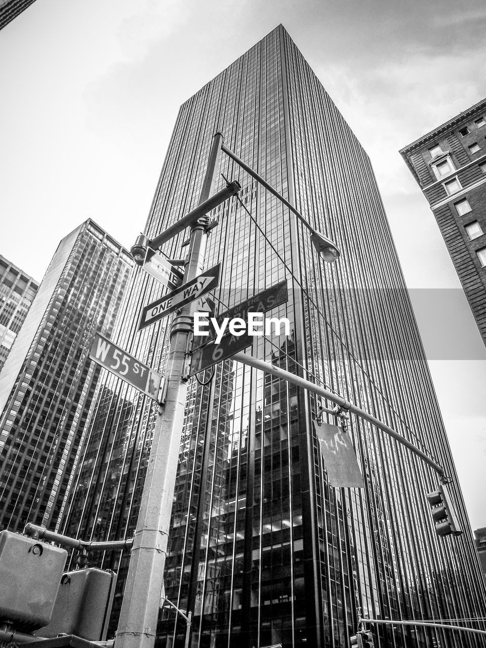 Low angle view of modern buildings against cloudy sky