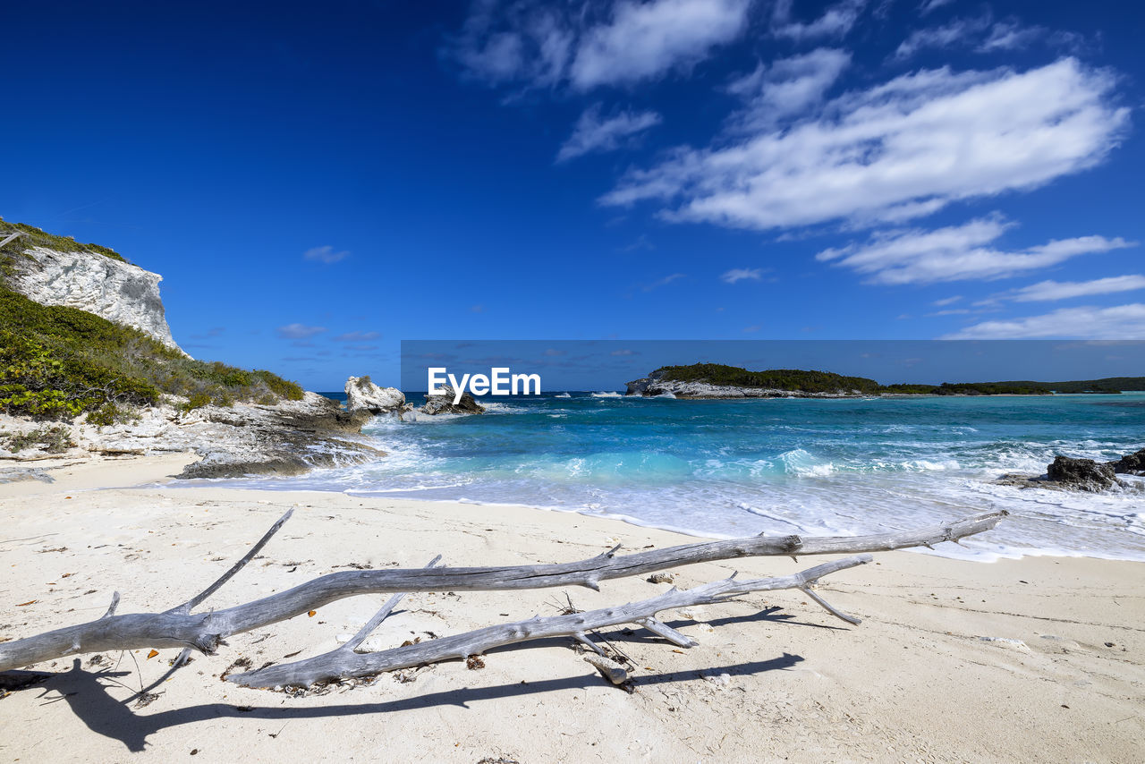 scenic view of beach against blue sky