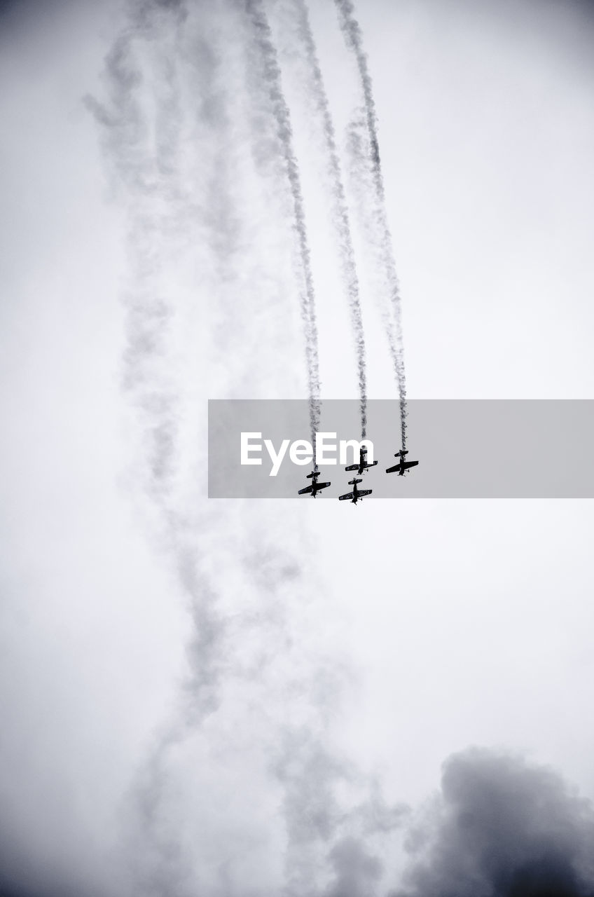 Low angle view of airshow in sky