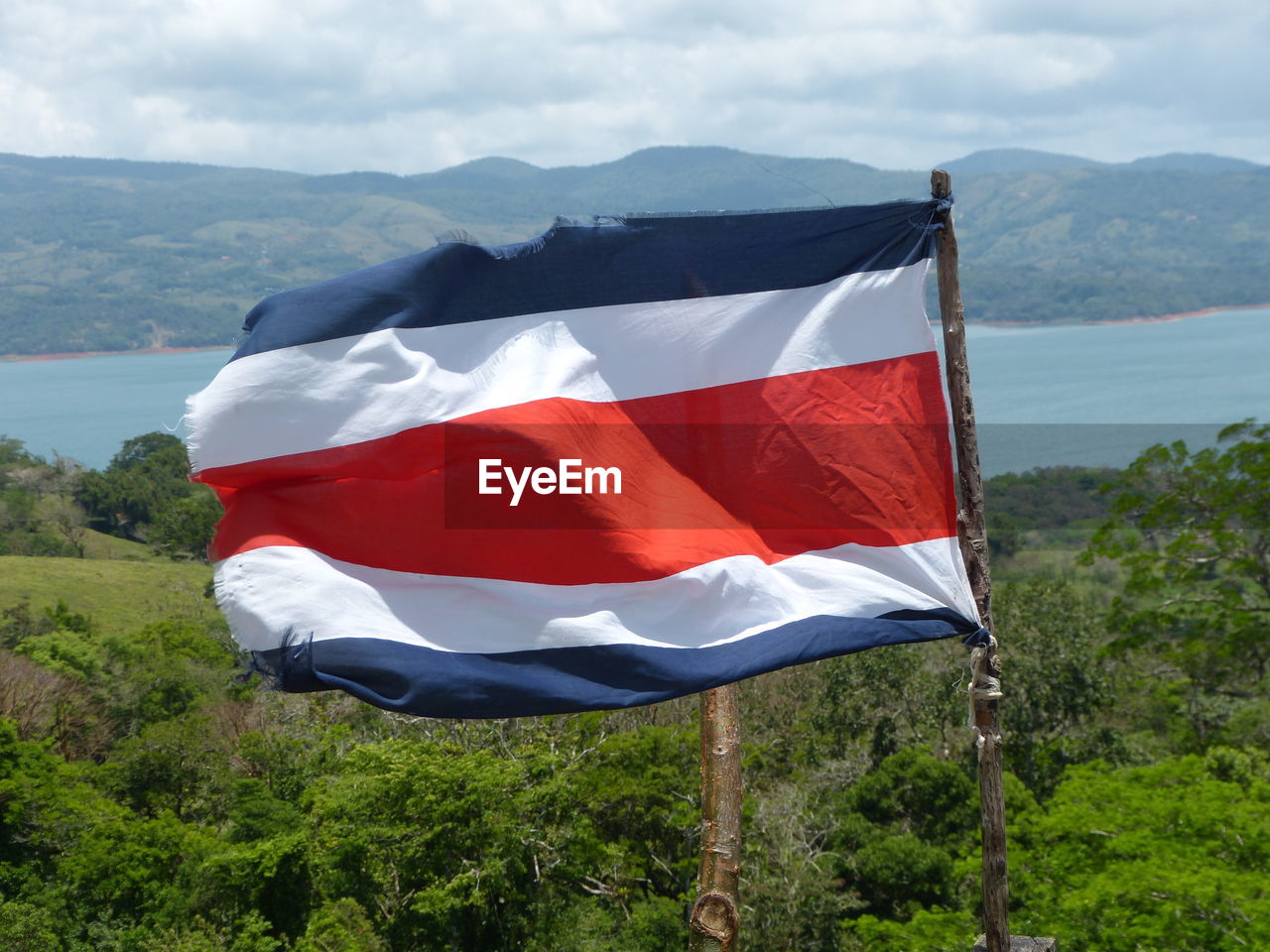 Scenic view of flag on mountain range against sky