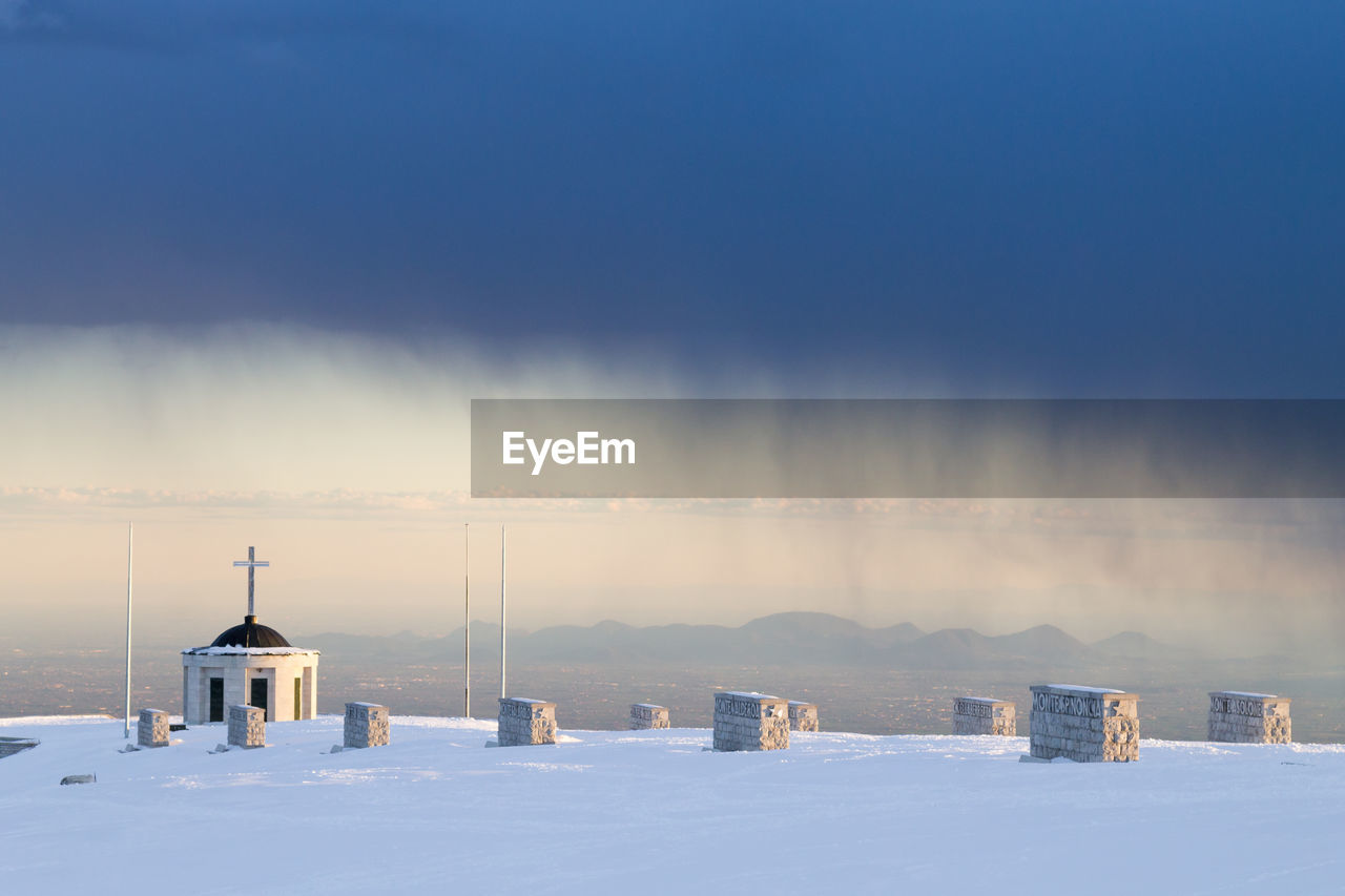 SNOW COVERED BUILT STRUCTURE AGAINST SKY