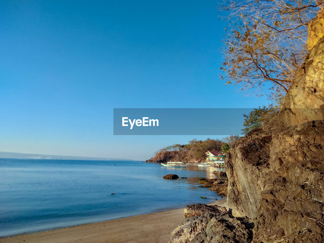 Scenic view of sea against clear blue sky