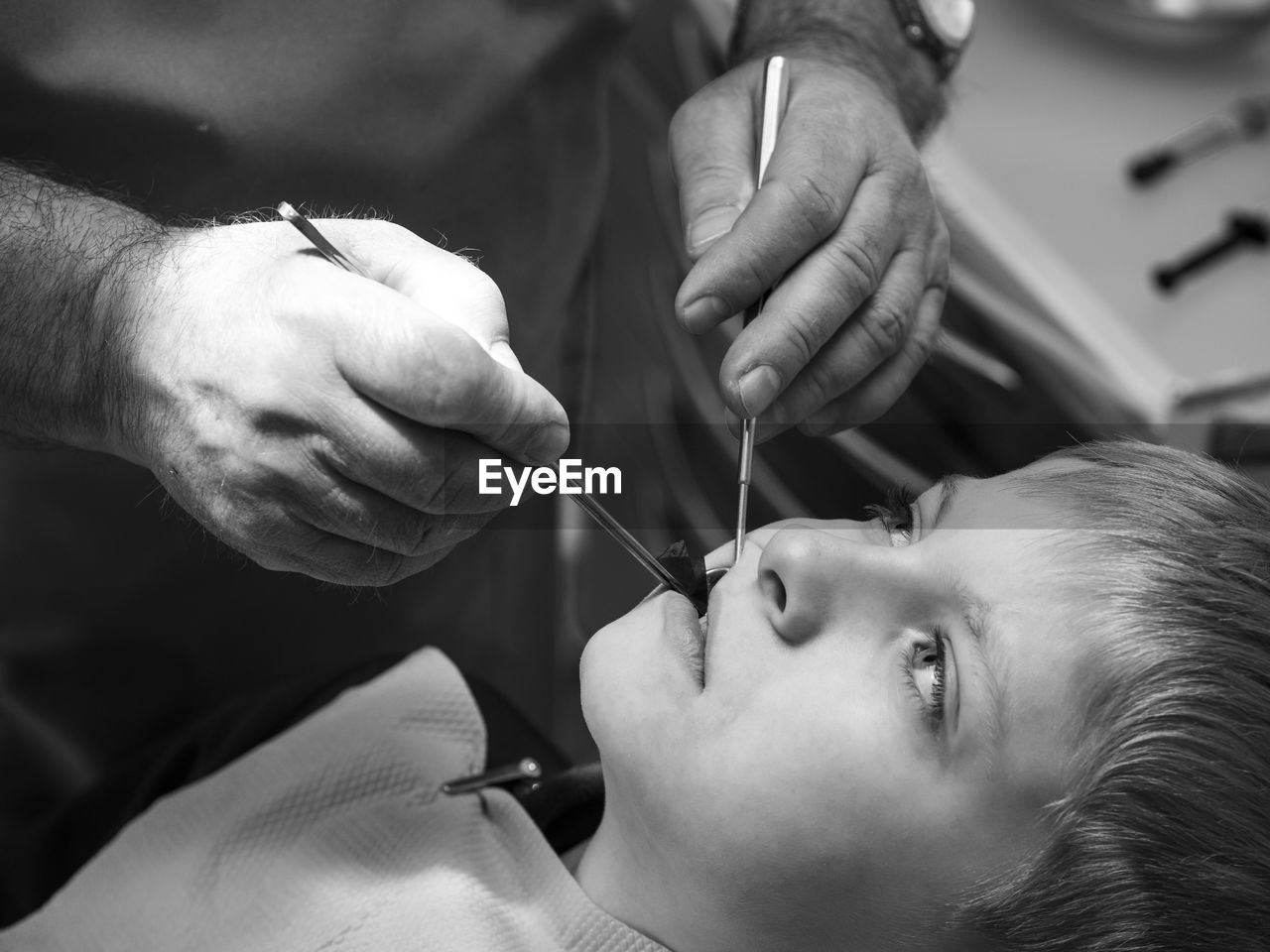 Close-up of dentist examining teeth of boy at clinic