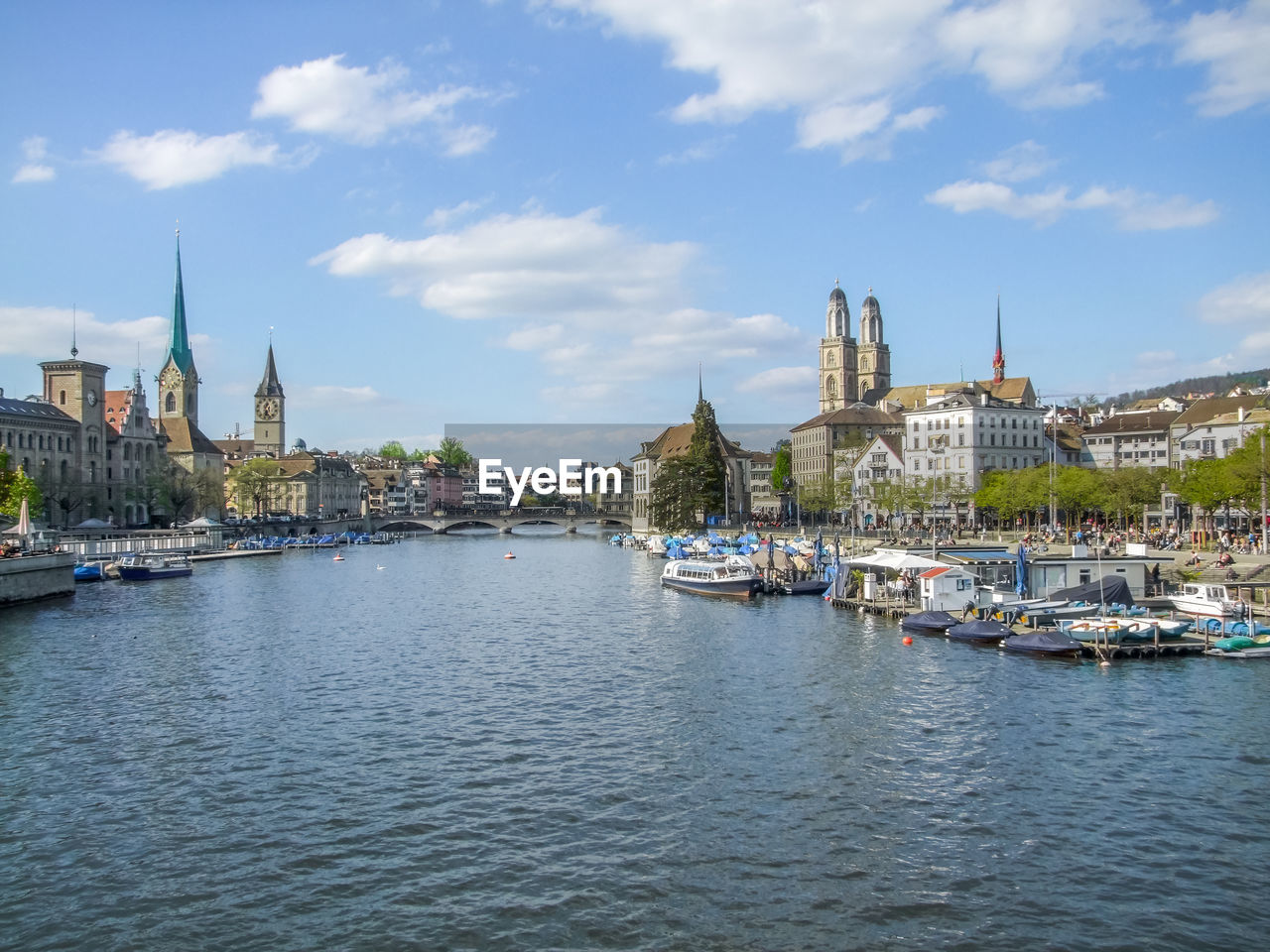 BOATS IN RIVER AGAINST BUILDINGS