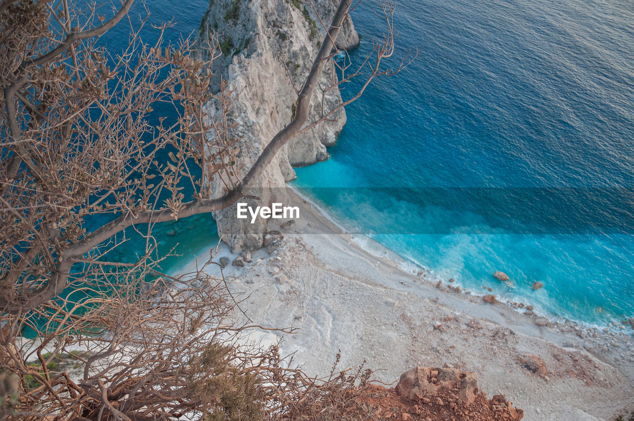 Close up of trees with blurred background of misithres cliffs, zakynthos island, greece