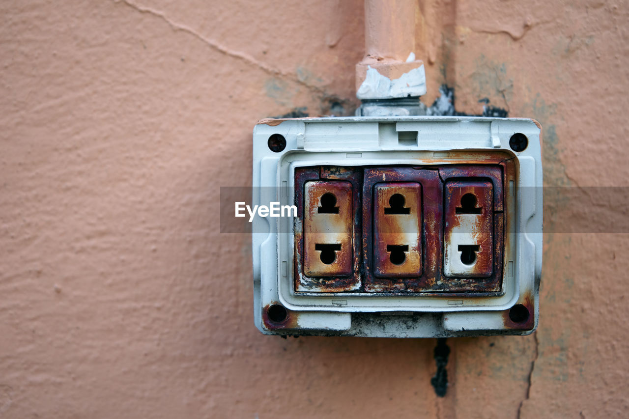 High angle view of old electric plug on wall