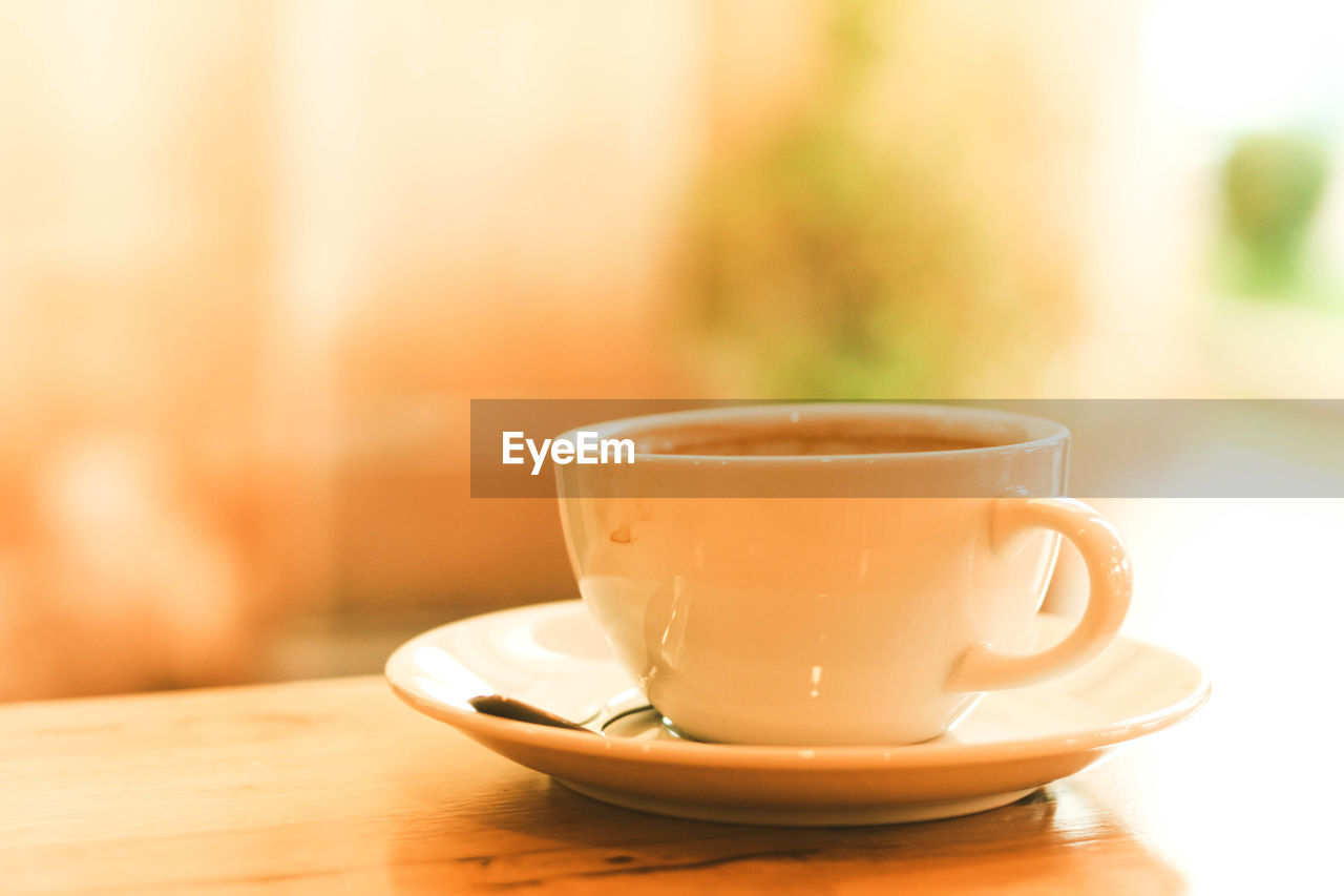 Cup of black coffee on wood table in the afternoon at cafe