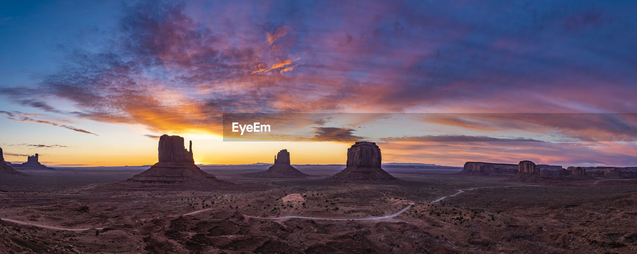 Panoramic view of rock formations against sky during sunset