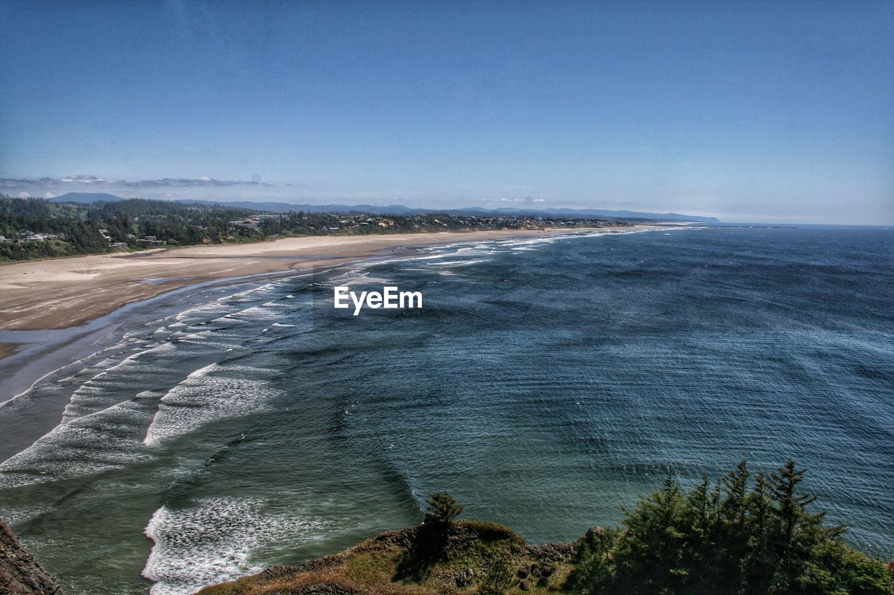 Scenic view of sea against clear blue sky