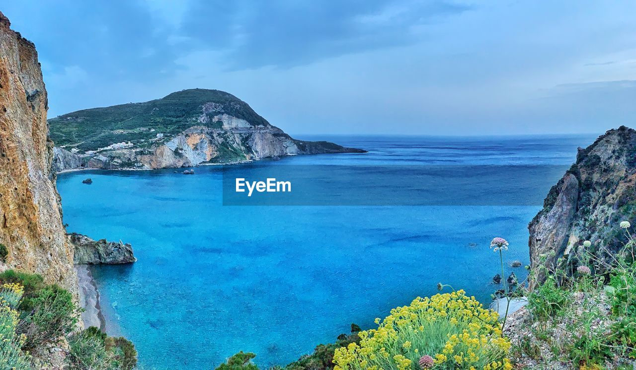 PANORAMIC VIEW OF SEA AND ROCKS AGAINST SKY