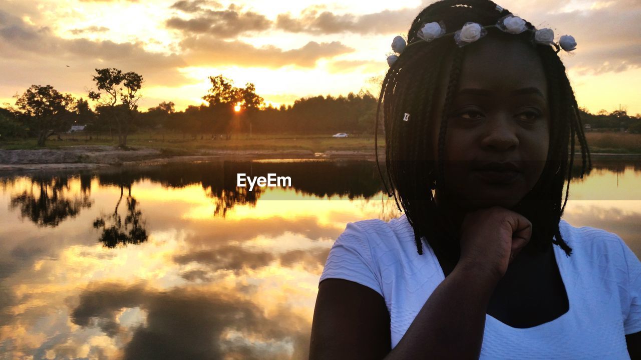 Woman against lake during sunset