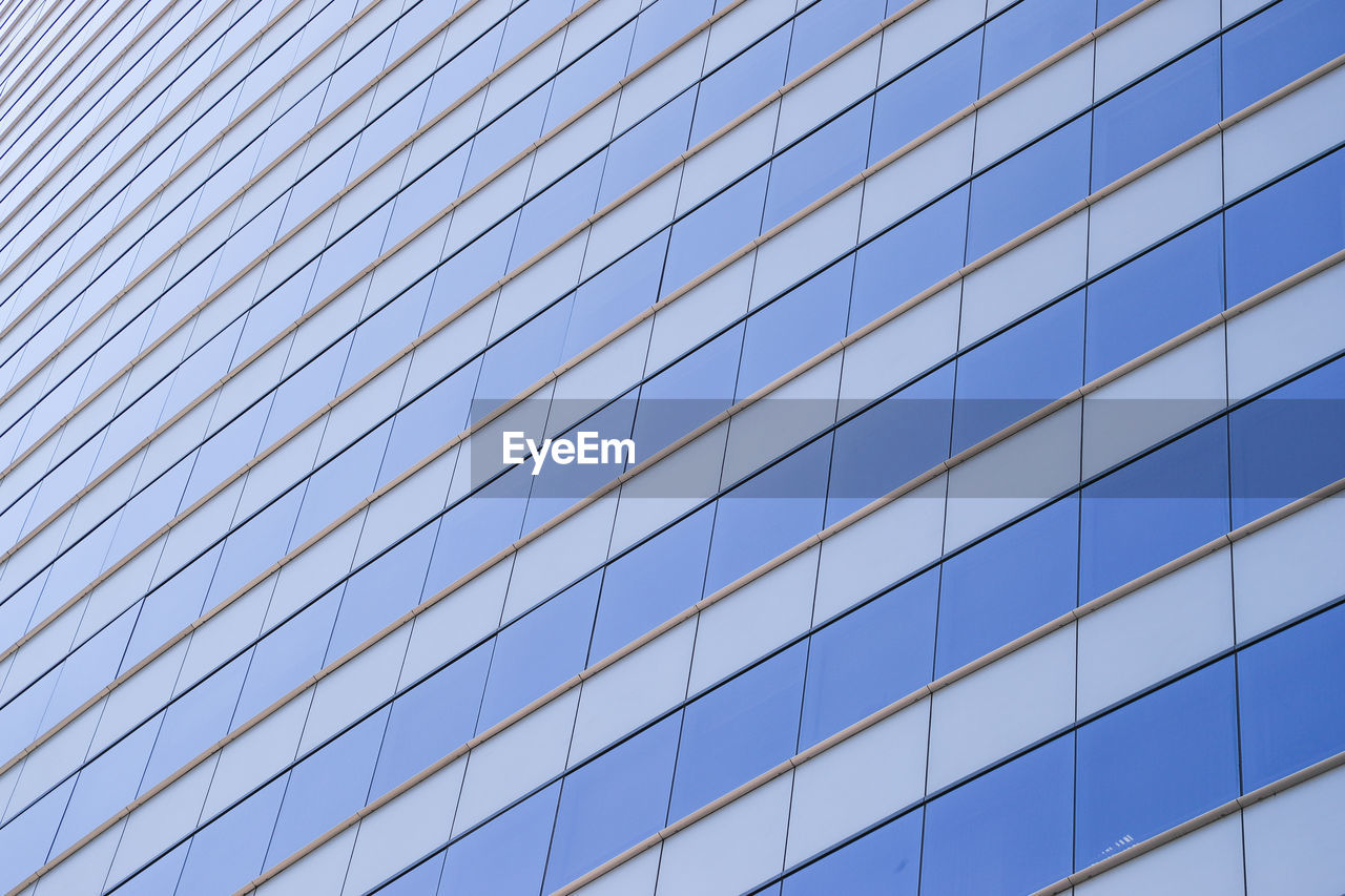 Low angle view of modern building against clear blue sky