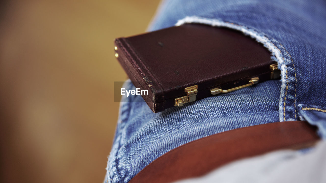Close-up of small briefcase in man pocket