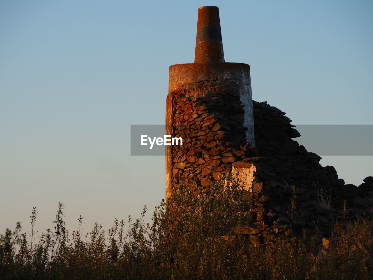 LOW ANGLE VIEW OF OLD TOWER AGAINST CLEAR SKY