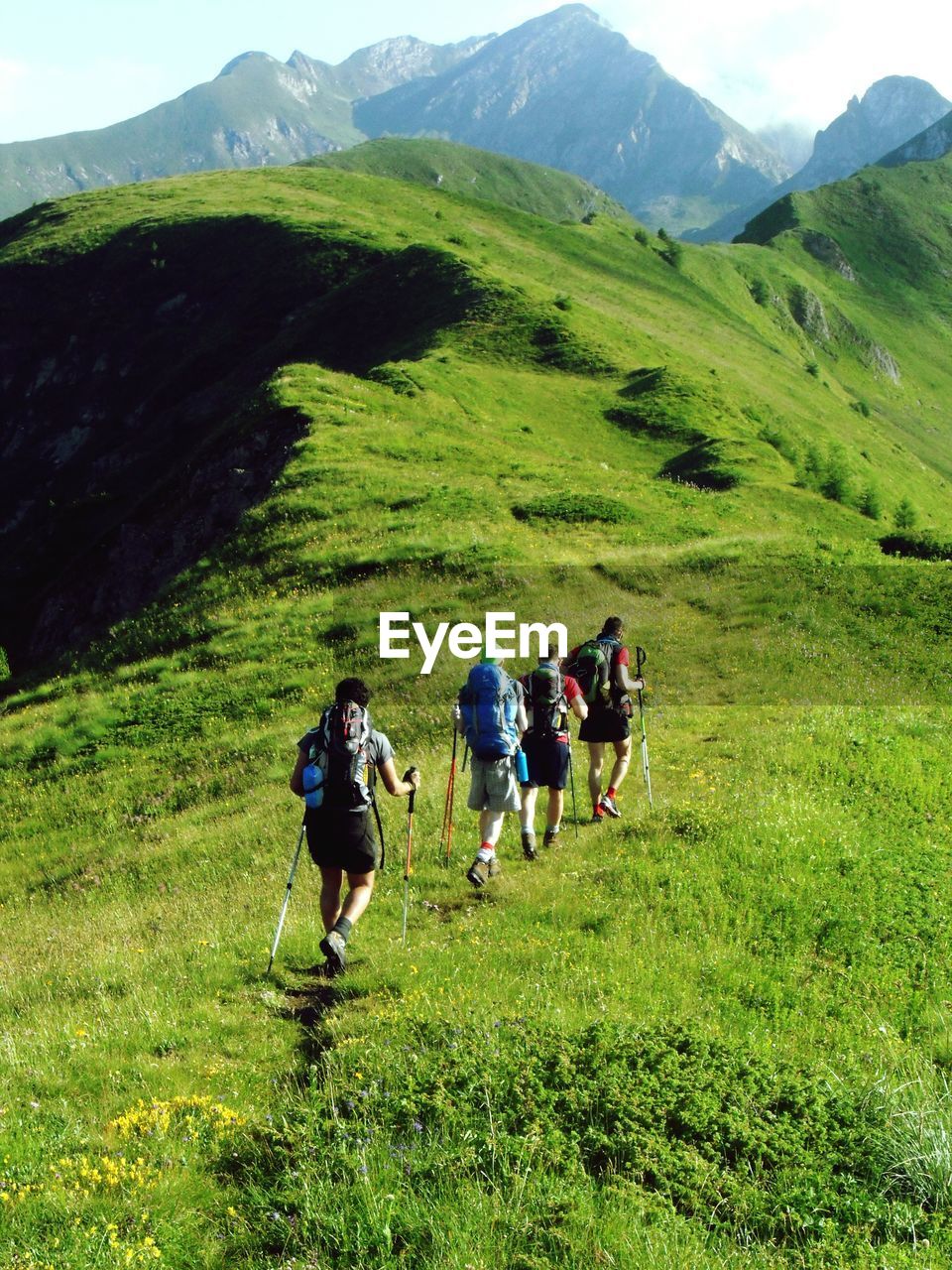 View of tourists hiking on hill