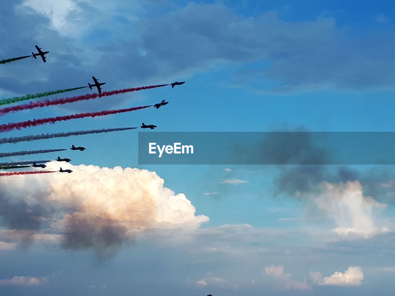 Low angle view of airplanes flying against sky