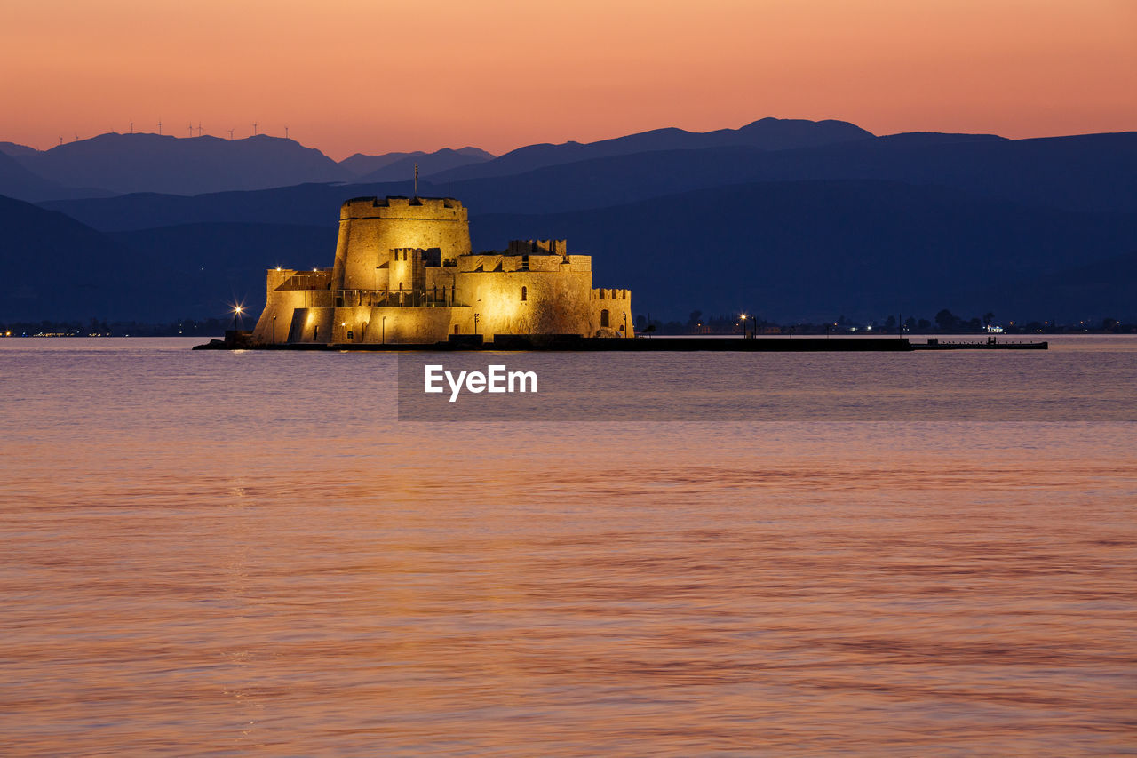 Scenic view of sea against sky during sunset, with the bourtzi fortress against the mountain