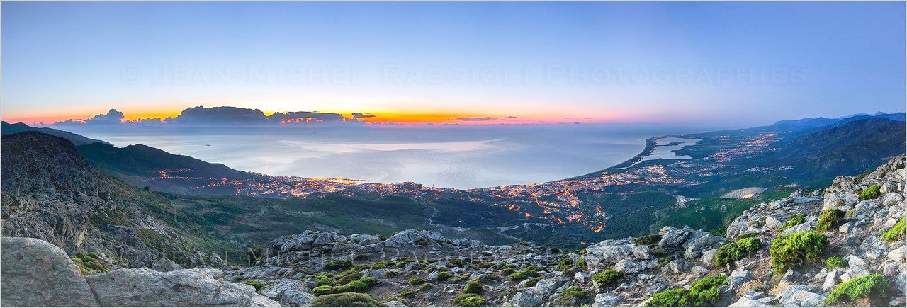 Panoramic view of landscape and lake during sunset