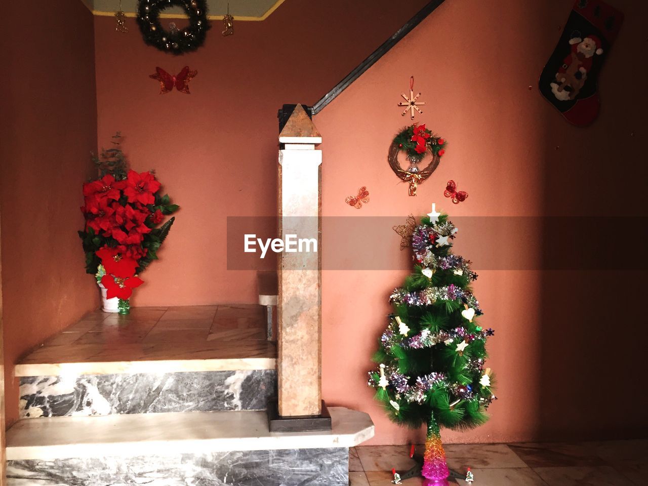 Artificial decorated christmas tree in house