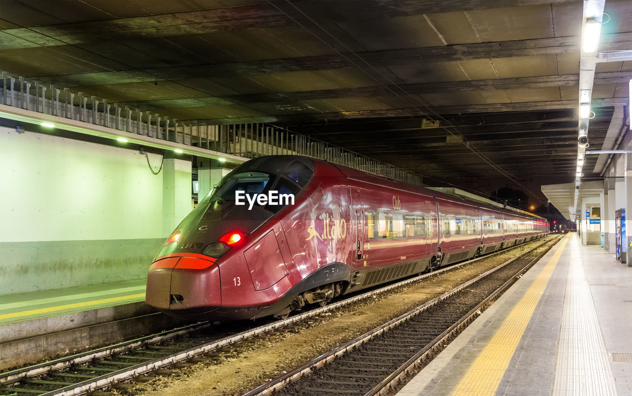 TRAIN IN RAILROAD STATION PLATFORM