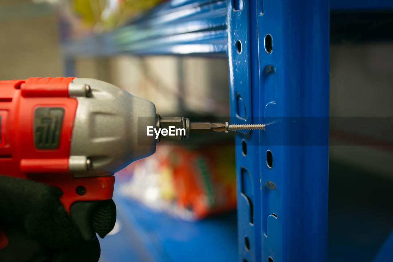 cropped image of man repairing machine