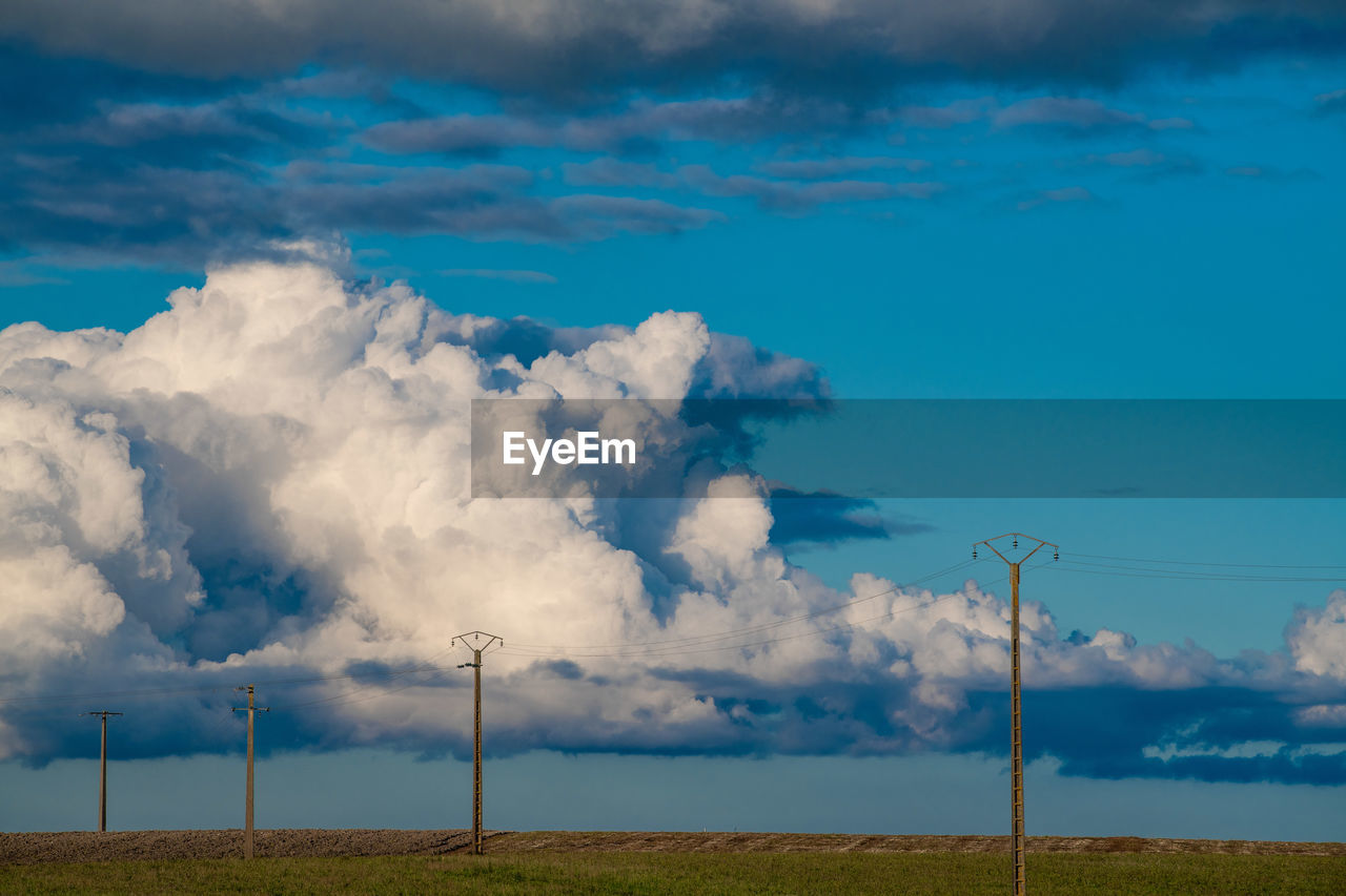 scenic view of field against cloudy sky