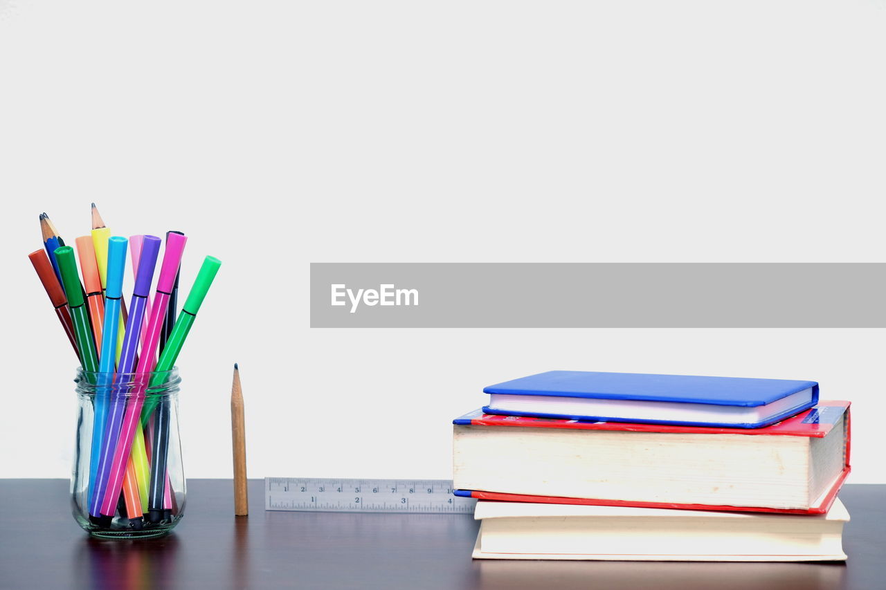 Close-up of multi colored school supplies on table