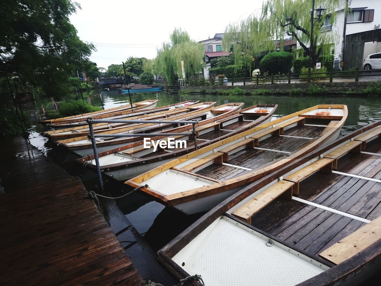 BOATS MOORED IN WATER AGAINST SKY