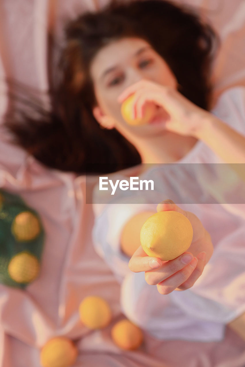 Directly above shot of woman holding lemon