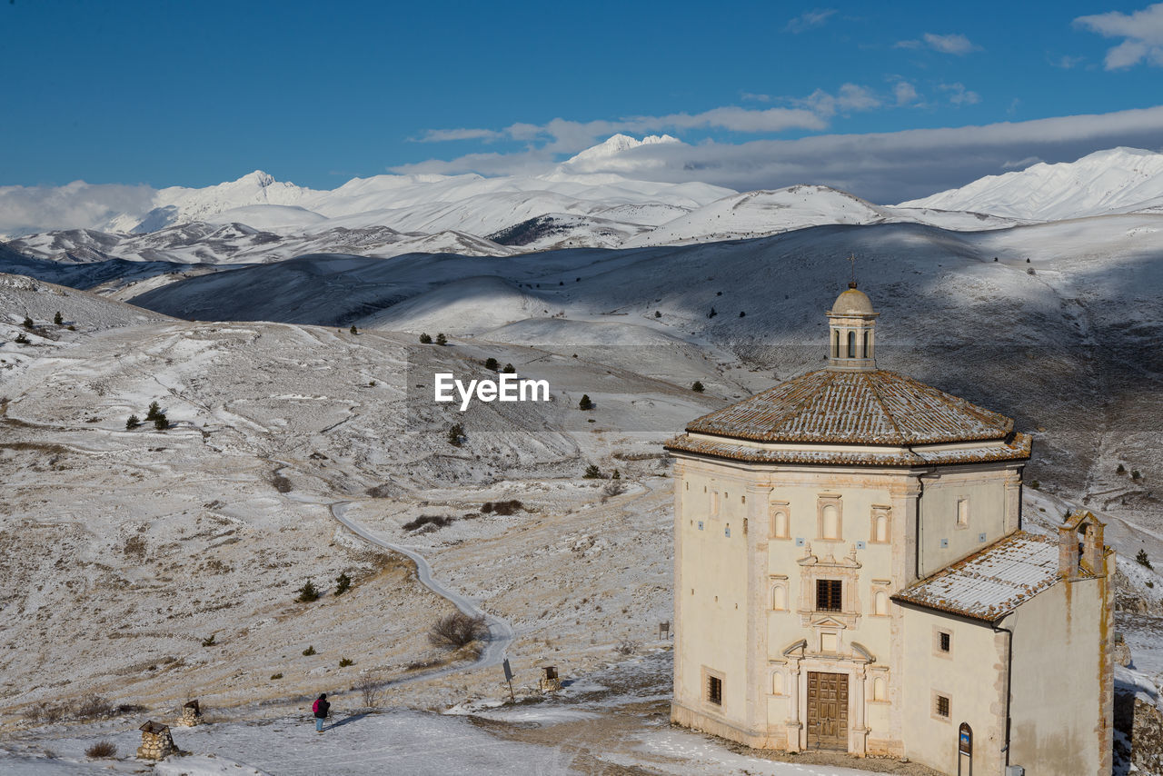 Ancient fortification and small church in the snowy mountains of abruzzo, italy
