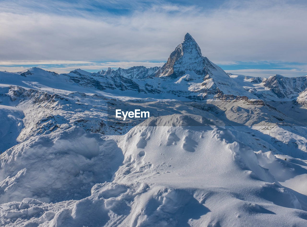 Scenic view of snowcapped mountains against sky