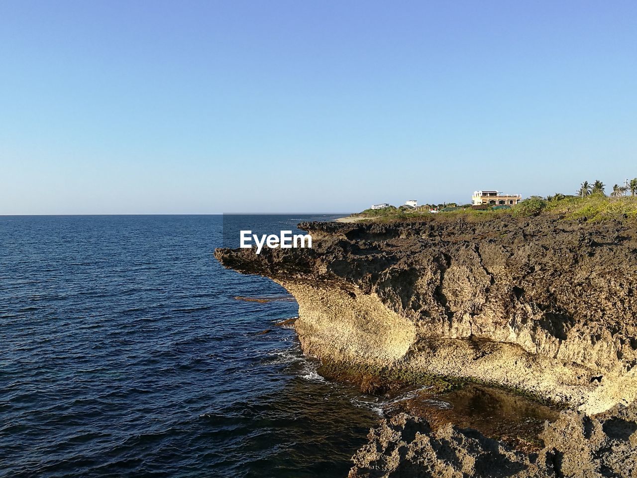 Scenic view of sea against clear blue sky