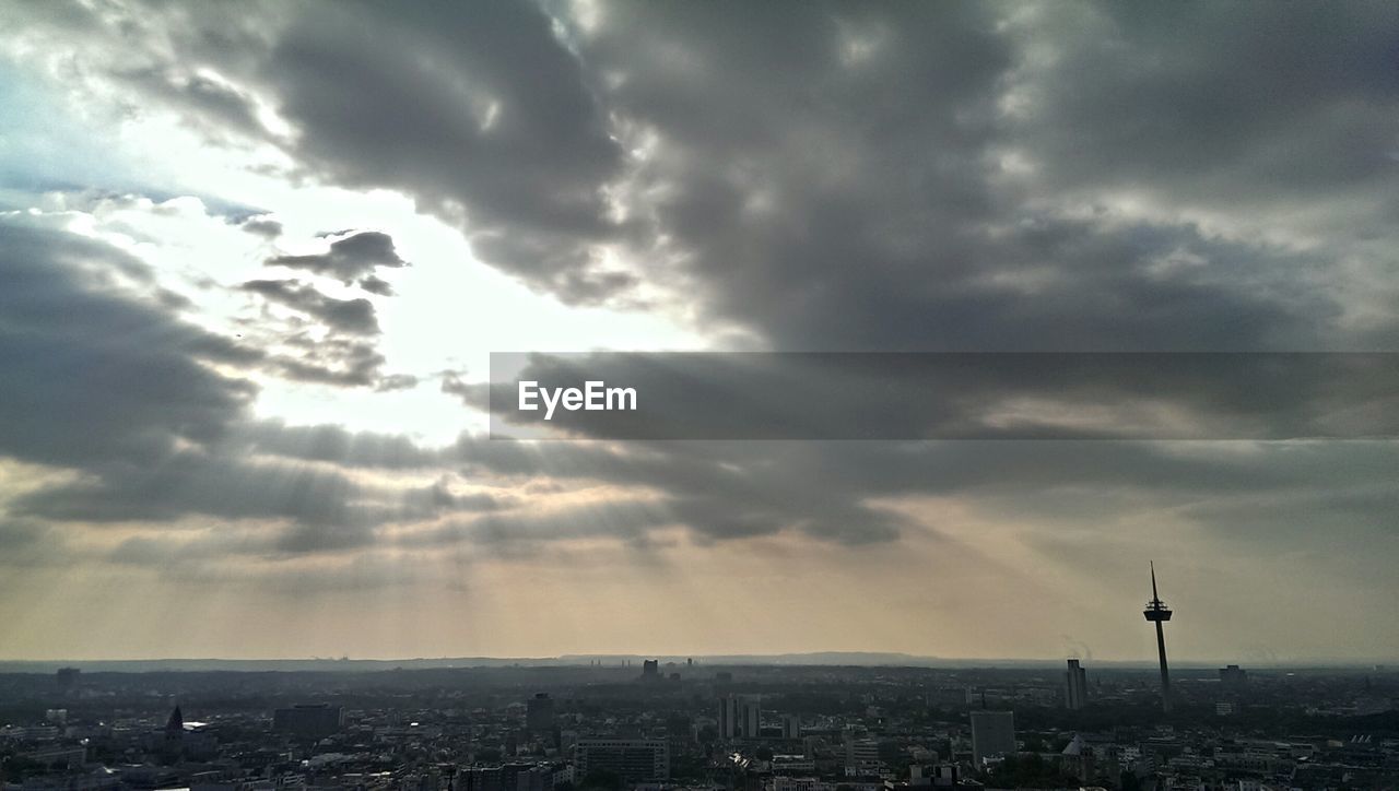 Scenic view of cityscape against cloudy sky