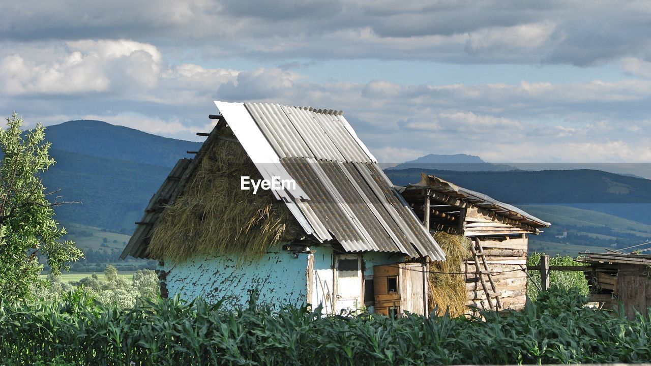 Houses on mountain against sky