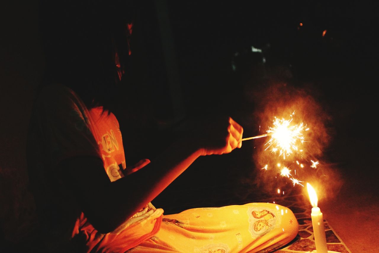 Girl plays sparkler fireworks in hand