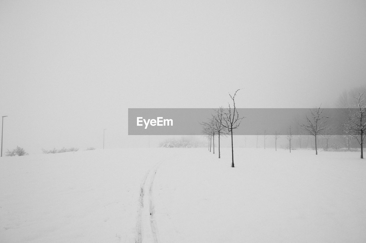 SNOW COVERED FIELD AGAINST SKY