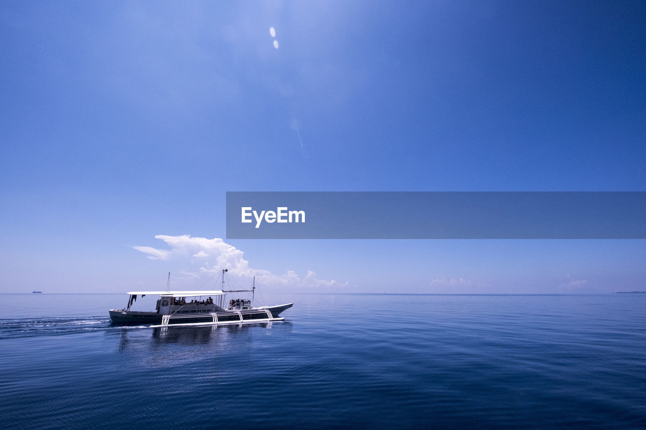 Scenic view of sea against blue sky