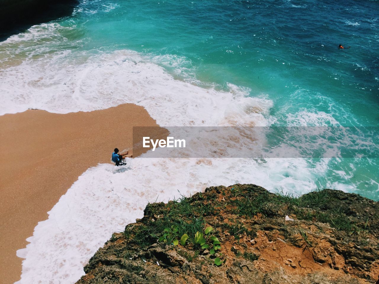 High angle view of man sitting at beach