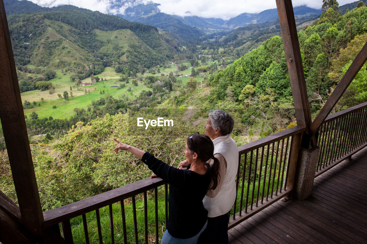 Senior mother and adult daughter traveling at the  view point over the cocora valley at salento