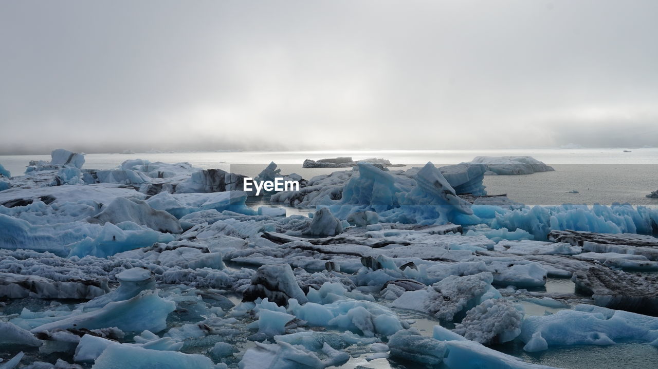 Scenic view of icebergs against sky