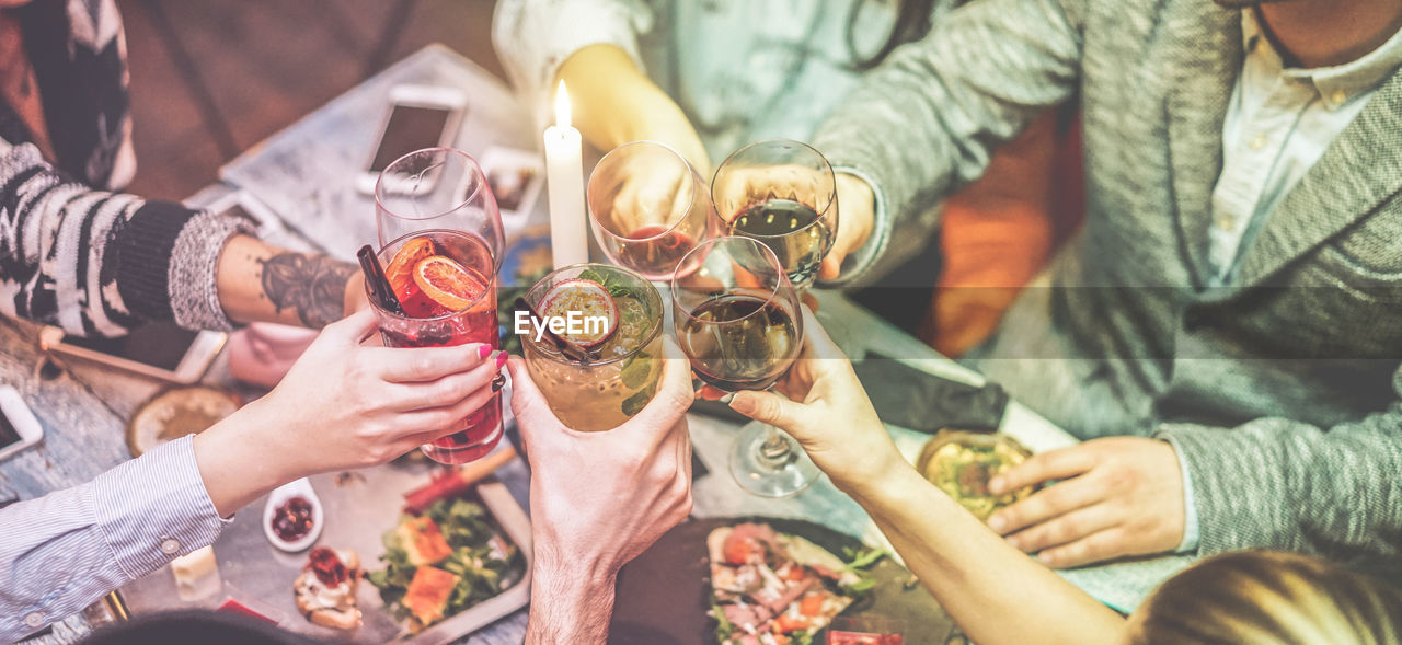 HIGH ANGLE VIEW OF PEOPLE DRINKING GLASS WITH DRINK