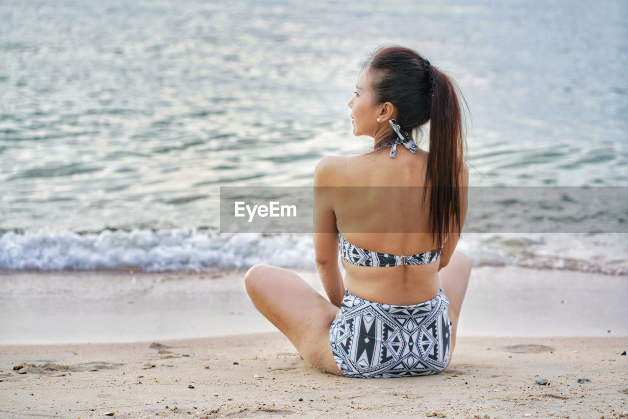 Young woman standing on beach