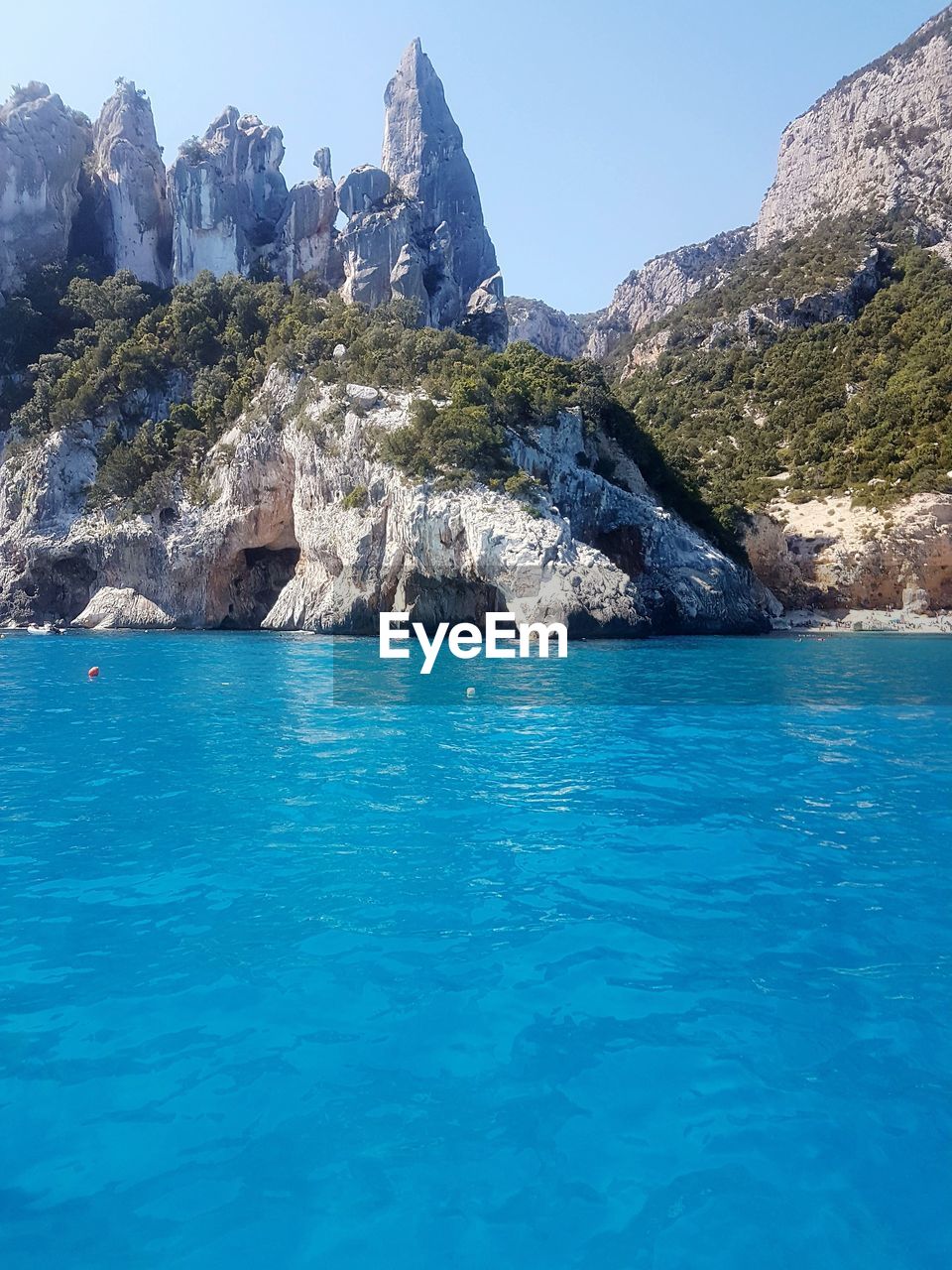 Scenic view of sea against clear blue sky