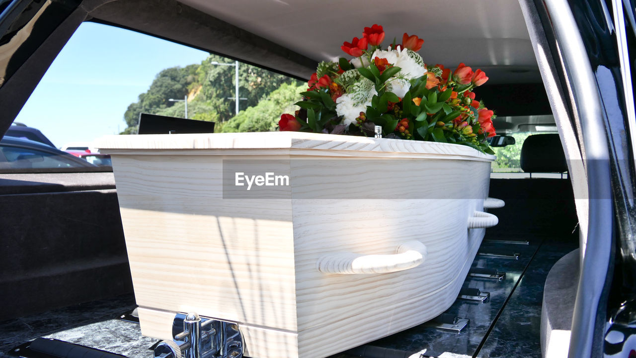 Closeup shot of a funeral casket in a hearse or chapel or burial at cemetery