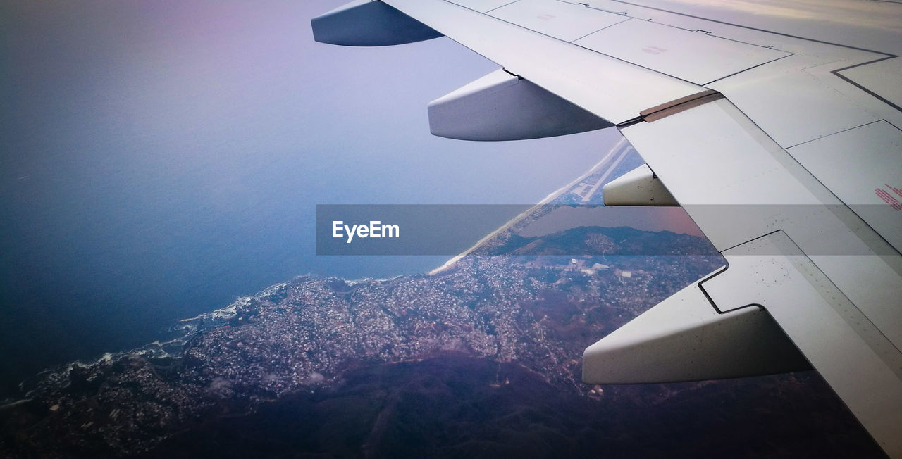 AERIAL VIEW OF AIRPLANE FLYING OVER SEA