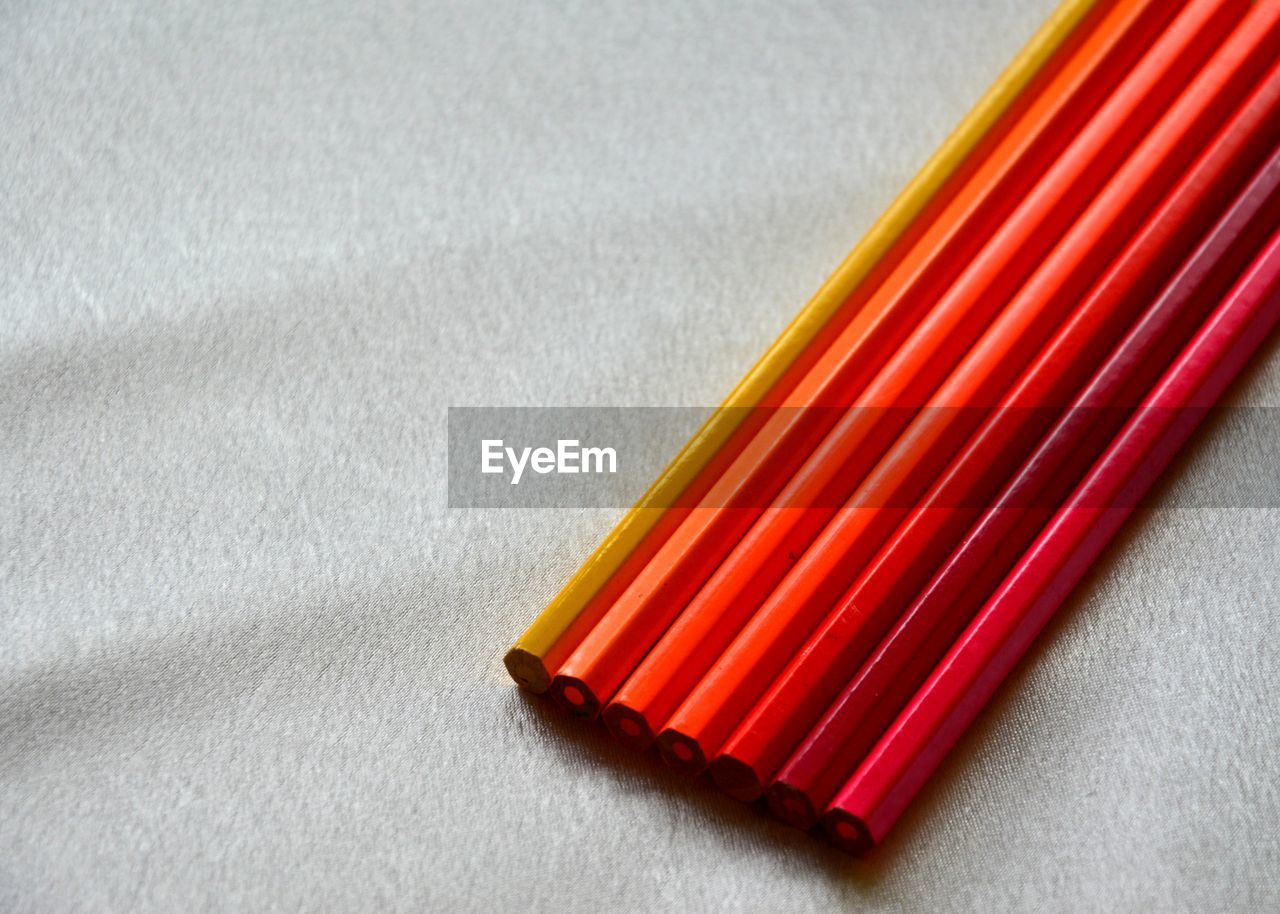 High angle view of colored pencils on white background