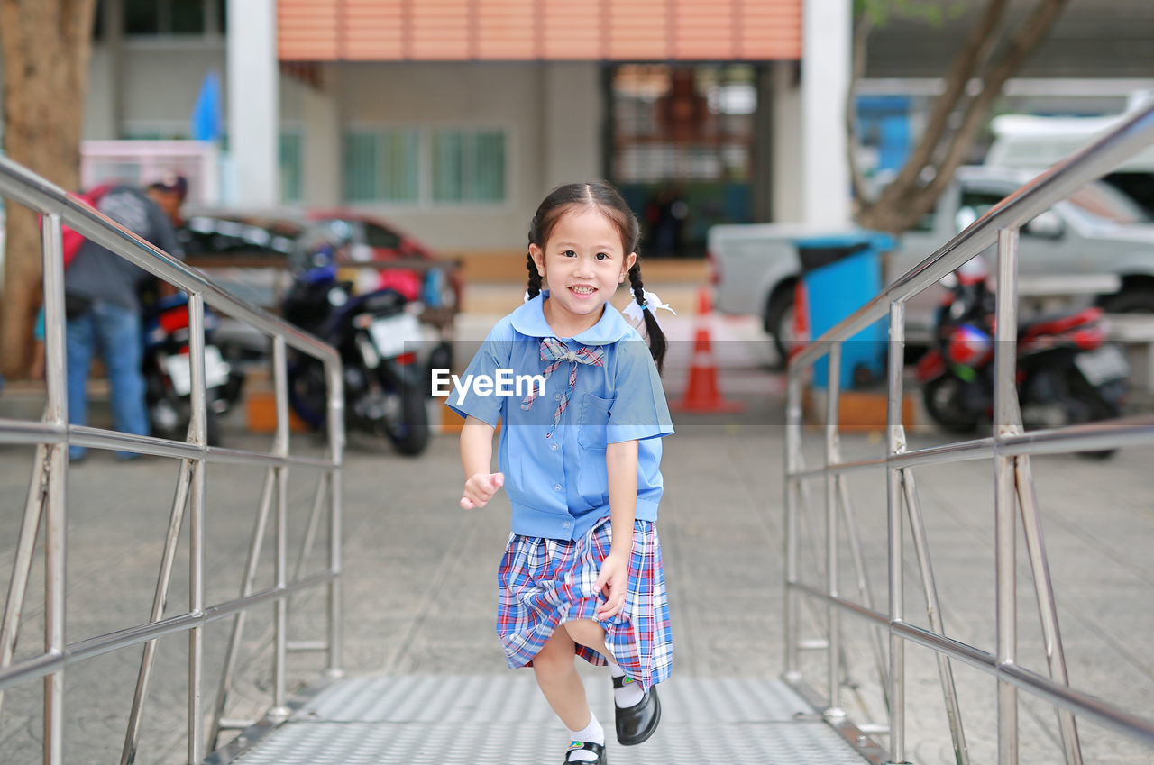 Portrait of cute girl running outdoors